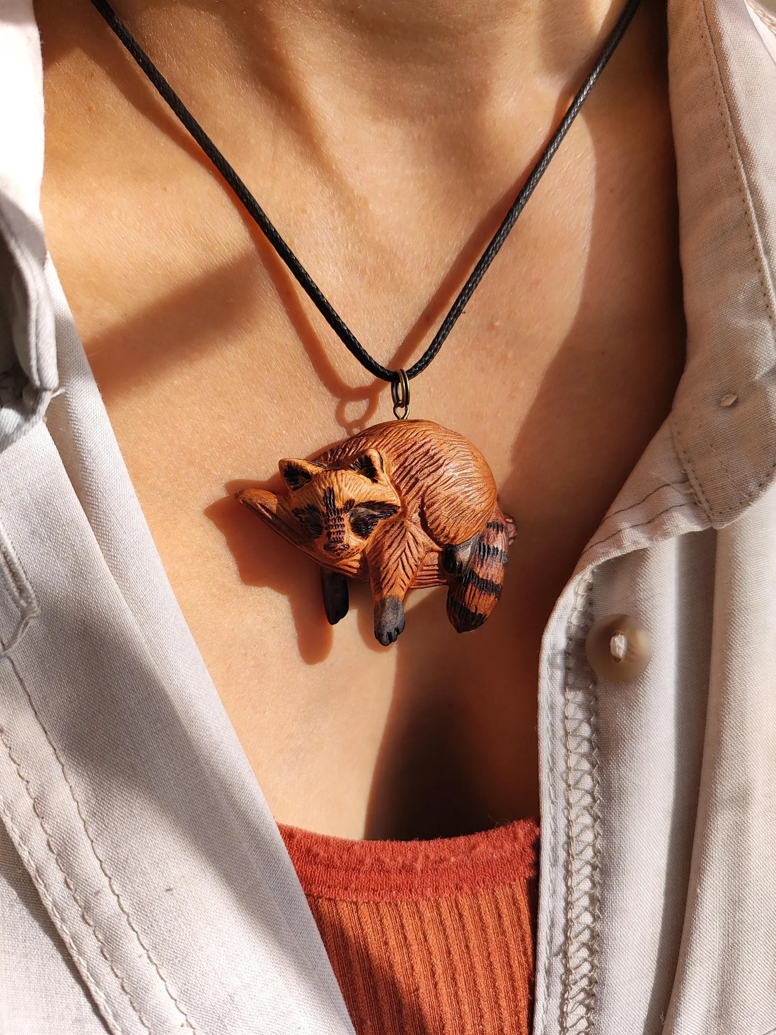 Sleeping raccoon pendant